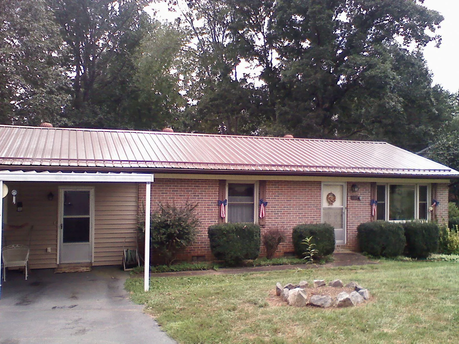 Bronze metal roof and carport on a brick ranch home — Roof Repair work by our crew in Teterboro